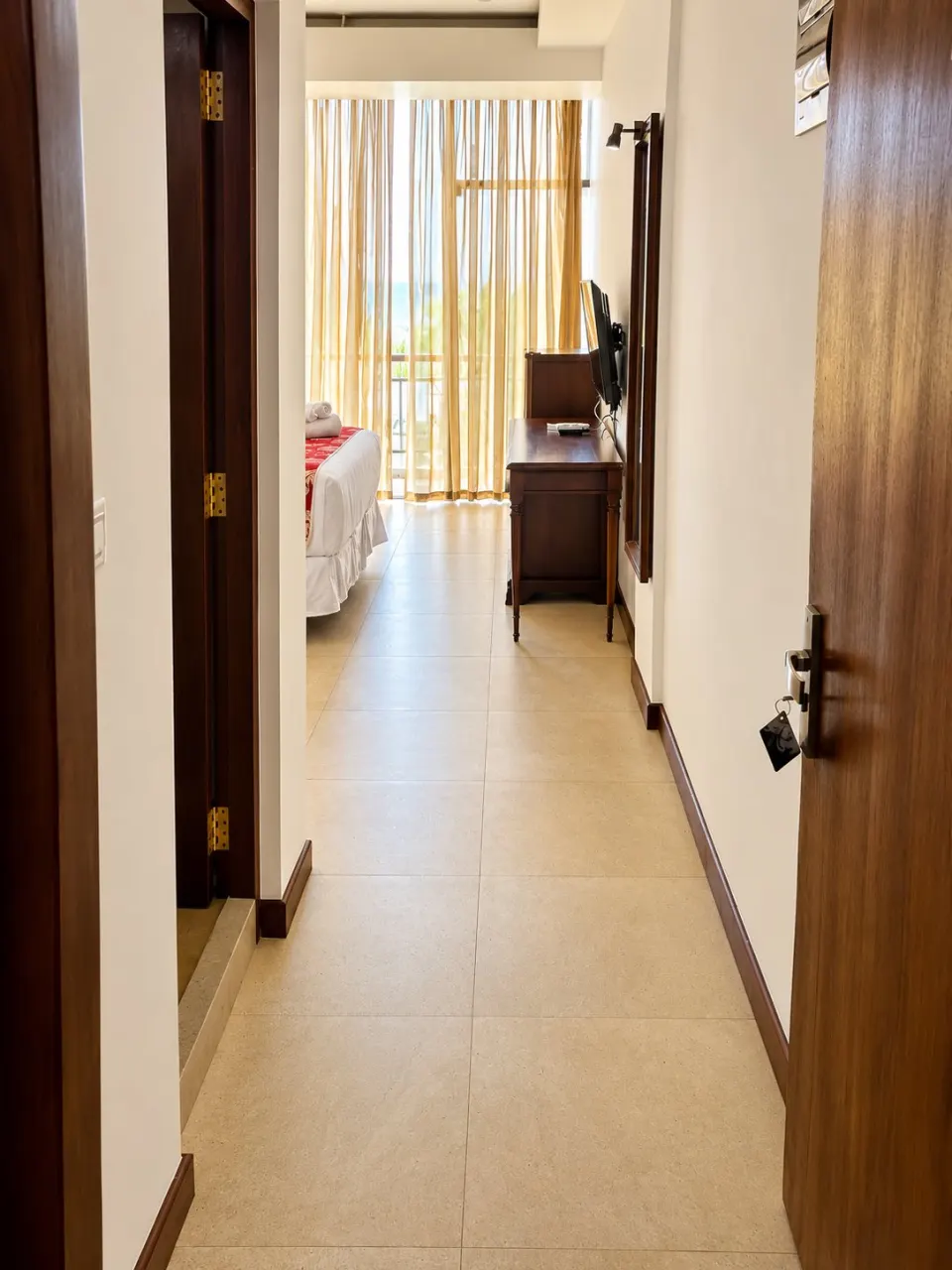 Sunlit Hotel Hallway to Balcony