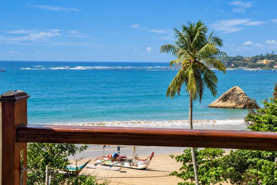 Turquoise bay and palm trees seen from a Bayfront balcony