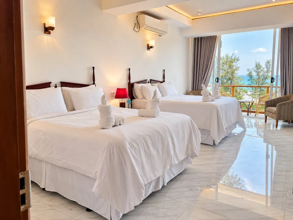 Luxury Sea Front with Private Balcony: bright coastal hotel room with twin beds