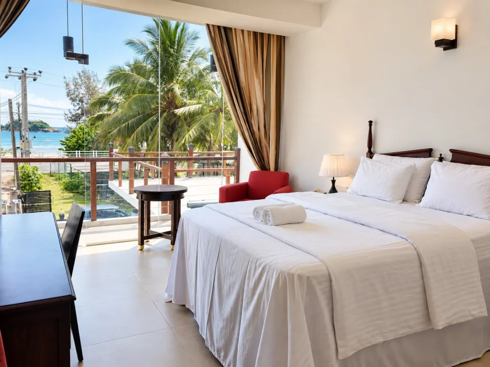 Luxury Sea Front with Private Balcony: coastal hotel bedroom with ocean view