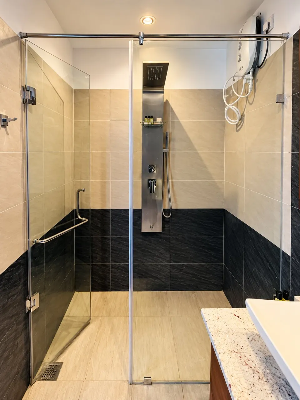 Sea View Deluxe Suite: modern beige and charcoal glass shower