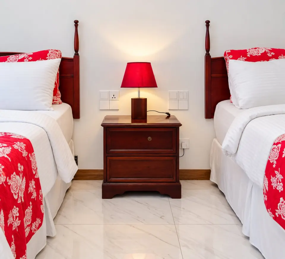 Luxury Beach Double Room: symmetrical twin bedroom with red floral accents